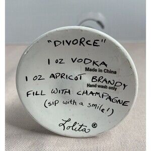 LOLITA - DIVORCE CHAMPAGNE FLUTE  GLASS HAND PAINTED. SOME PAINT WEAR ON GLASS.